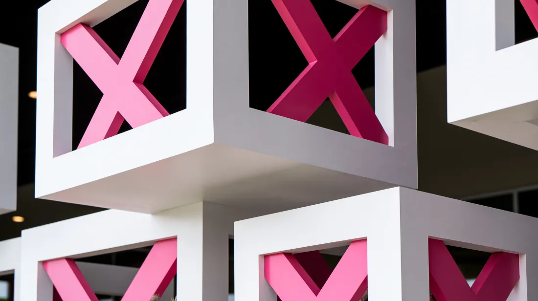 Bold magenta X shapes set in white cubes
